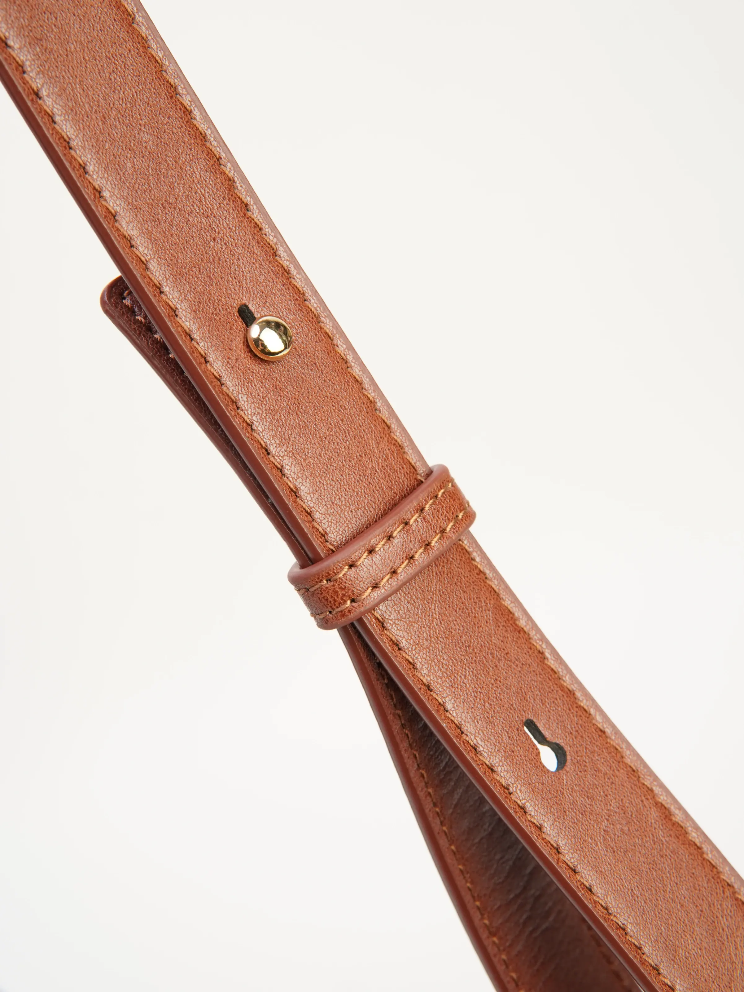 Close view of Mara adjustable shoulder strap and eyelets