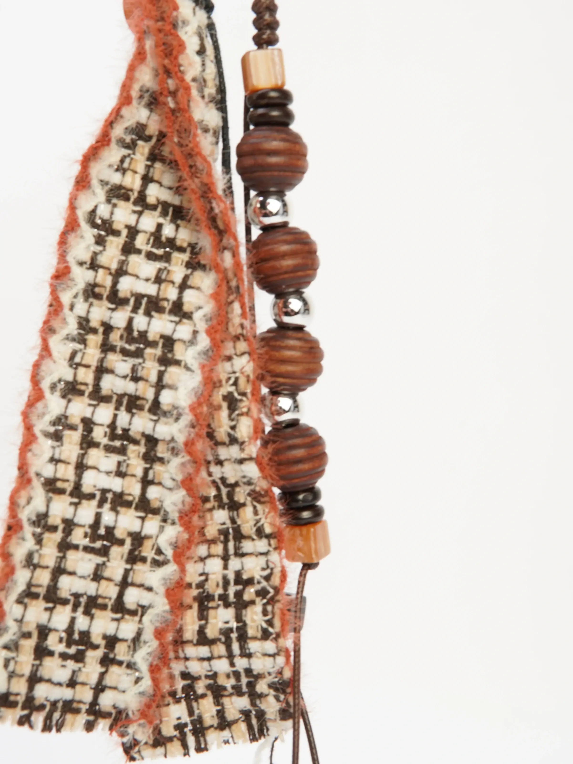 Close view of Rue patterned ribbon and bead accents
