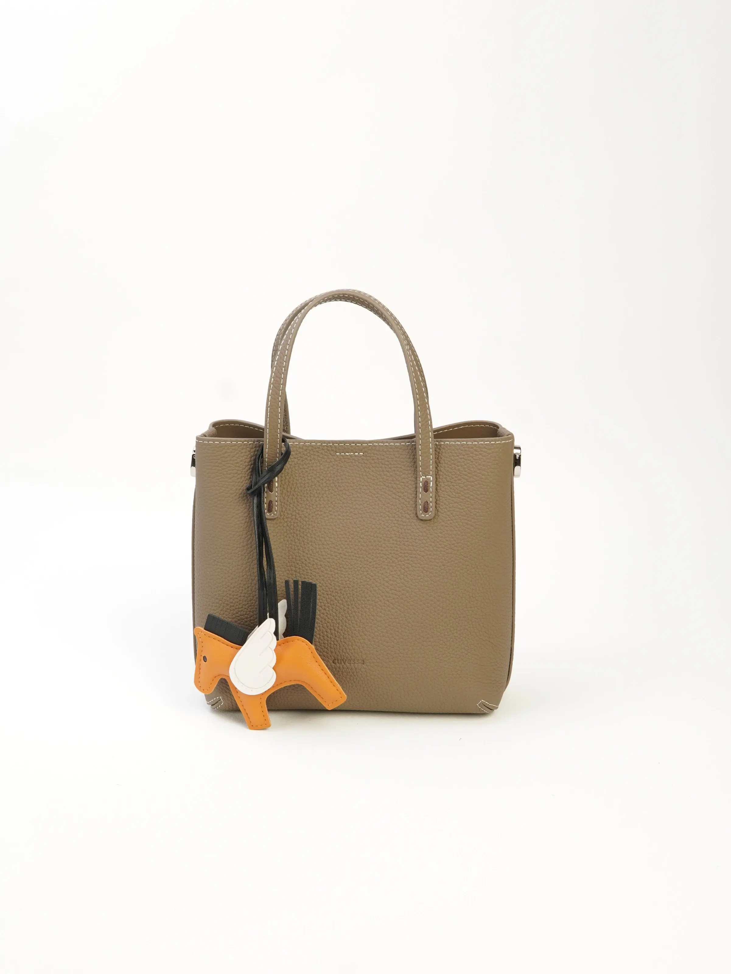 Front view of Lena taupe tote with twin handles and a styled orange horse-shaped charm