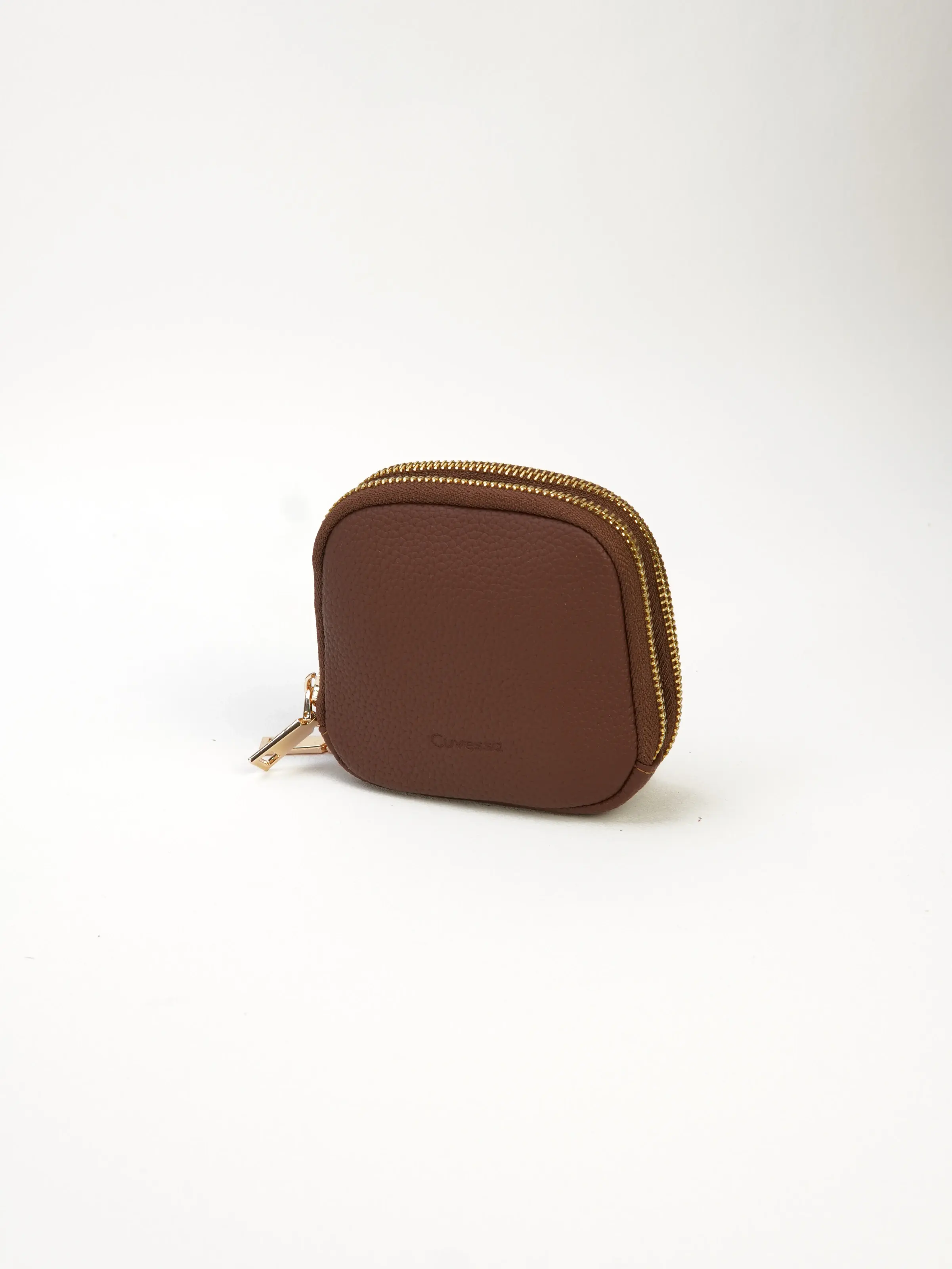 Nia cocoa double-zip jewelry case at a three-quarter angle, showing its rounded shape